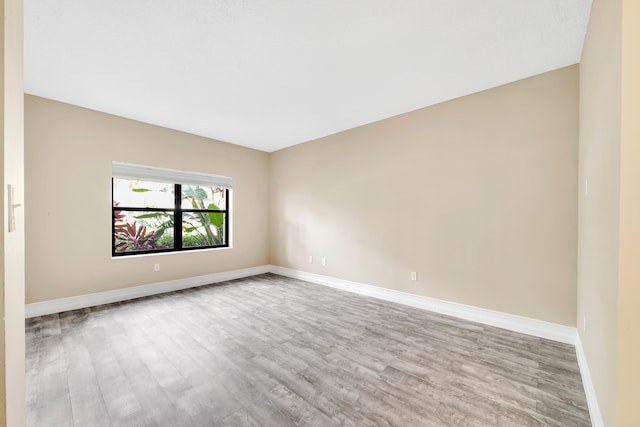 empty room with light hardwood / wood-style flooring