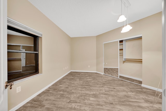 unfurnished bedroom with a closet and wood-type flooring