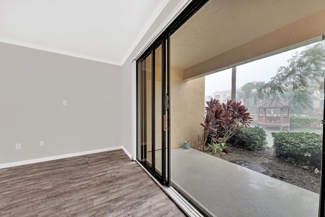 interior space featuring crown molding and wood-type flooring