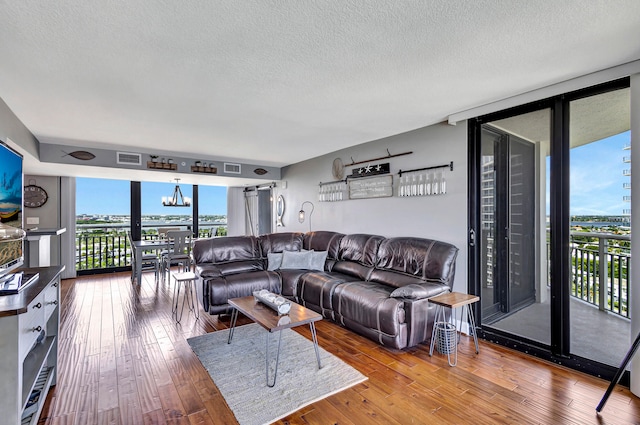 living room featuring light hardwood / wood-style flooring and a textured ceiling