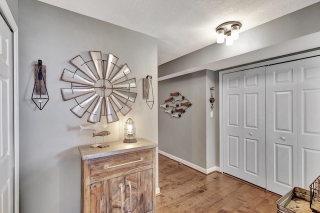 foyer with light hardwood / wood-style floors and a textured ceiling