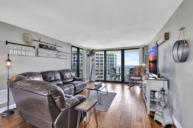 living room featuring expansive windows and hardwood / wood-style flooring