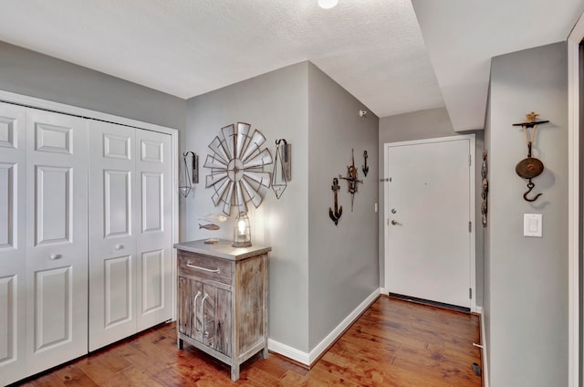 foyer featuring a textured ceiling and hardwood / wood-style floors