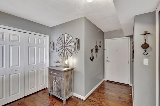 entrance foyer featuring wood-type flooring and a textured ceiling