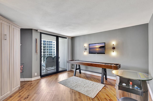 entryway with light hardwood / wood-style flooring and a textured ceiling