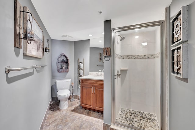 bathroom with vanity, a shower with door, and toilet