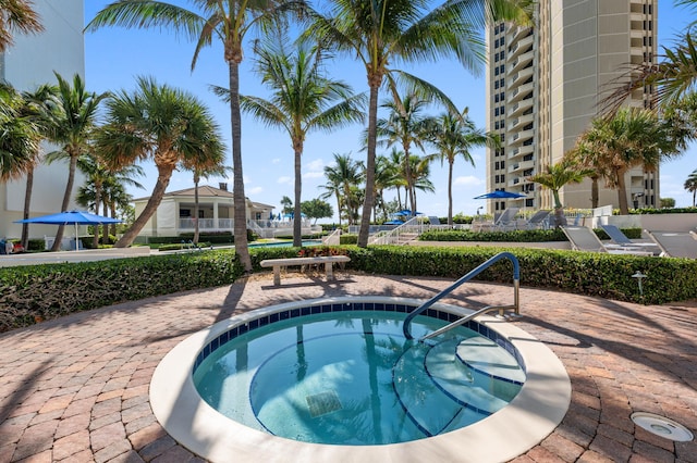 view of swimming pool with a community hot tub and a patio area