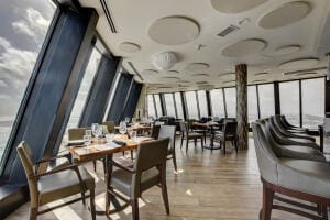 dining area with a wall of windows and a wealth of natural light