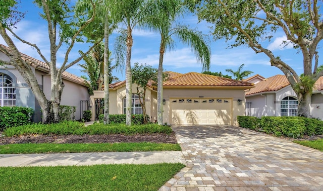 mediterranean / spanish-style home with a garage