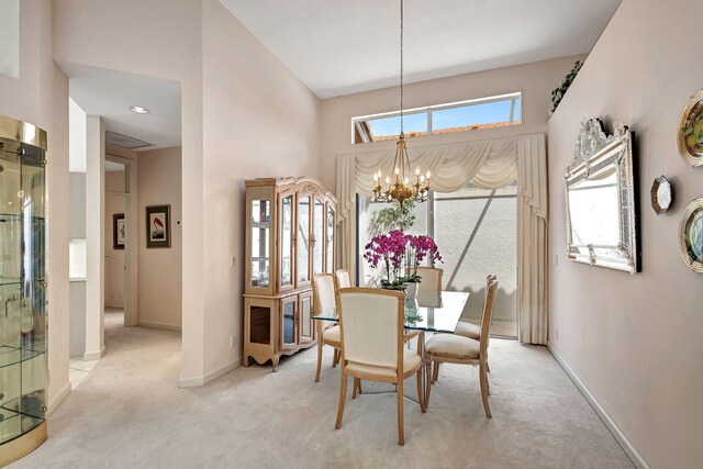 carpeted dining area featuring a notable chandelier, plenty of natural light, and a high ceiling