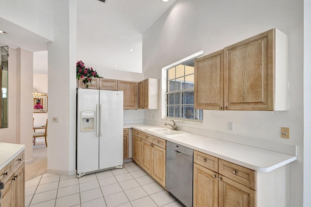 kitchen with sink, light tile patterned flooring, white fridge with ice dispenser, and dishwasher