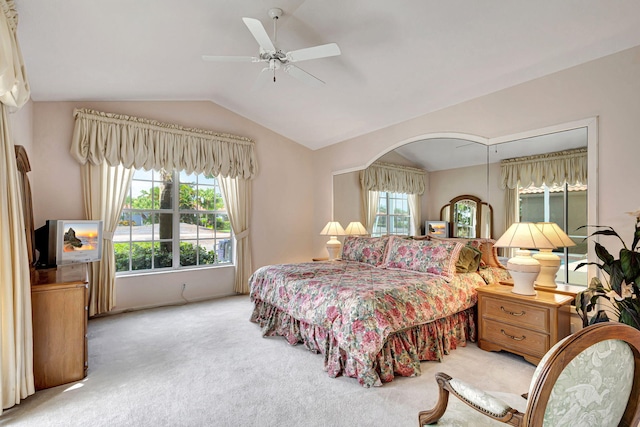 carpeted bedroom featuring ceiling fan and lofted ceiling