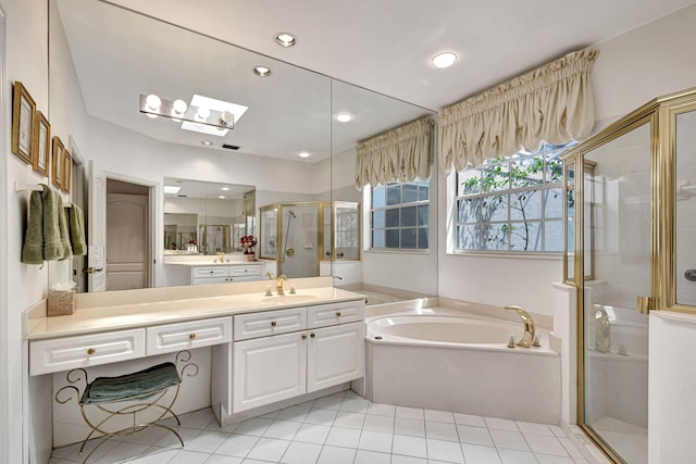 bathroom with tile patterned floors, separate shower and tub, and vanity