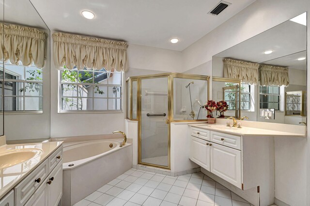 bathroom with tile patterned flooring, separate shower and tub, and vanity