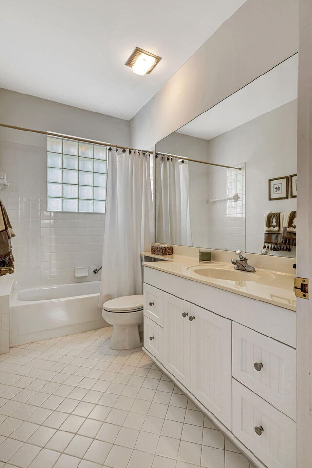 full bathroom with tile patterned flooring, toilet, vanity, and shower / tub combo