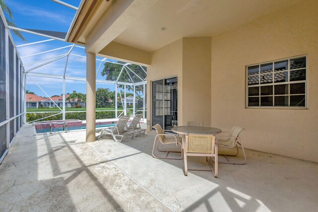 view of patio with glass enclosure