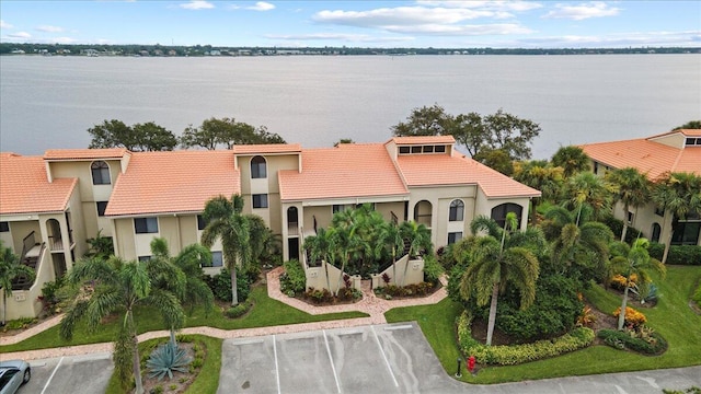 birds eye view of property with a water view