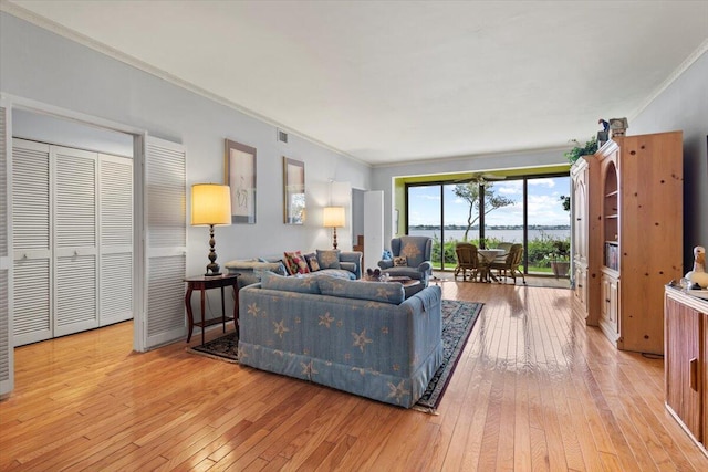 living room featuring light hardwood / wood-style flooring and crown molding