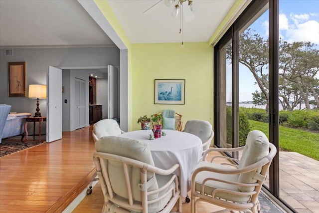 sunroom / solarium featuring ceiling fan