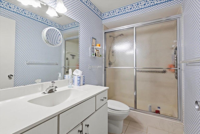 bathroom featuring an enclosed shower, vanity, tile patterned floors, and toilet