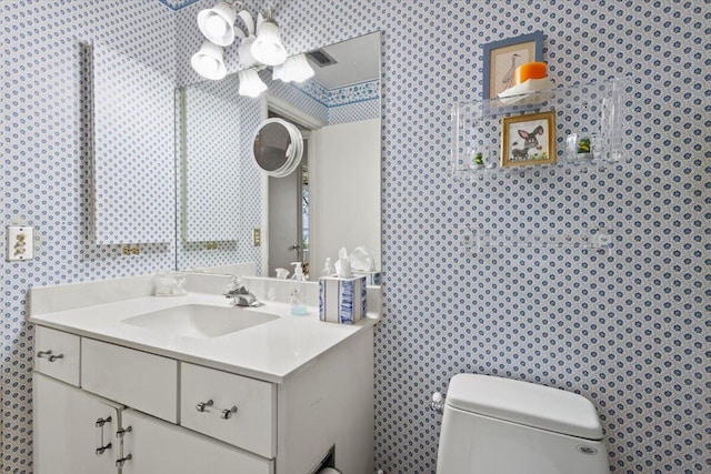 bathroom featuring vanity and toilet