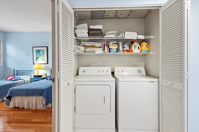 washroom with hardwood / wood-style floors and independent washer and dryer