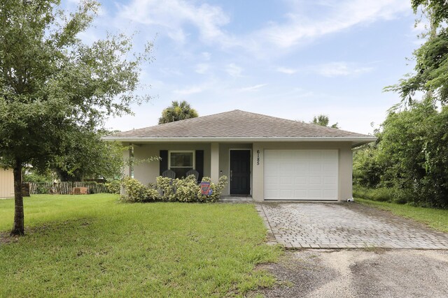 single story home with a front lawn and a garage