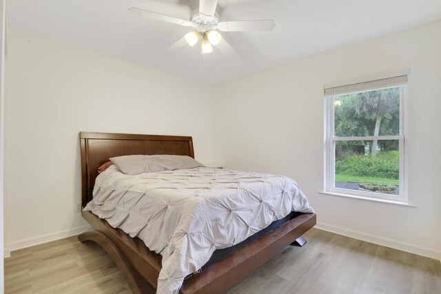 bedroom with light hardwood / wood-style flooring and ceiling fan