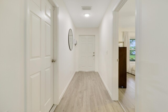 corridor with light wood-type flooring