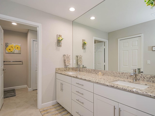 bathroom with dual vanity and tile patterned flooring