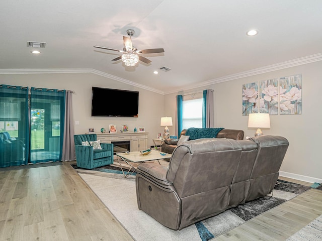 living room with ceiling fan, crown molding, light wood-type flooring, and lofted ceiling