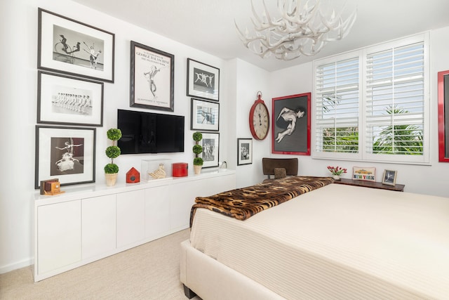 bedroom featuring light carpet and an inviting chandelier