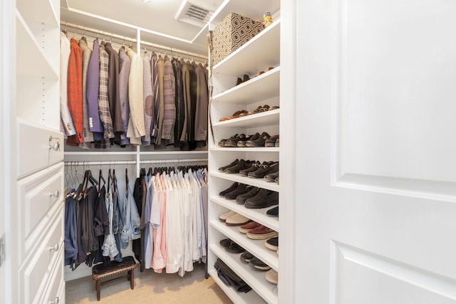 walk in closet featuring carpet flooring