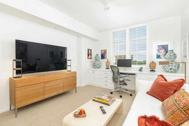 carpeted home office with built in desk