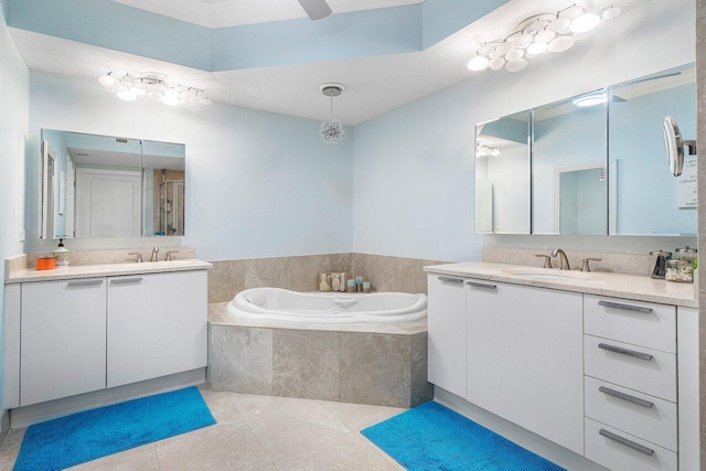 bathroom with dual vanity, ceiling fan, a relaxing tiled tub, and tile patterned flooring