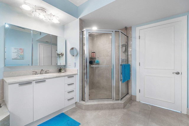 bathroom featuring an enclosed shower, tile patterned floors, and vanity