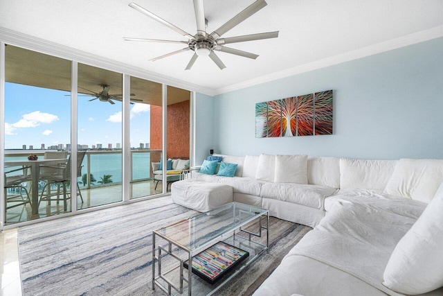 living room featuring ceiling fan, a water view, a wall of windows, and ornamental molding