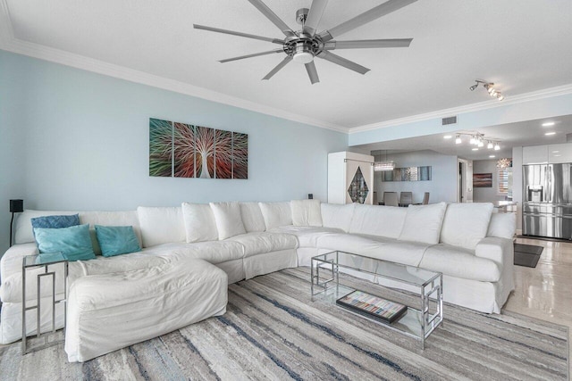 living room featuring ceiling fan and crown molding