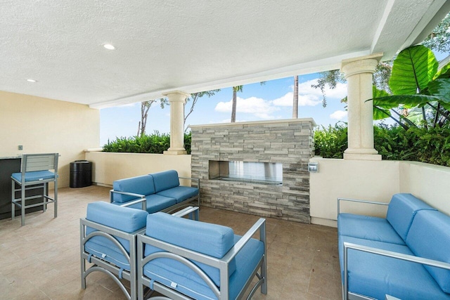 view of patio / terrace featuring an outdoor living space with a fireplace