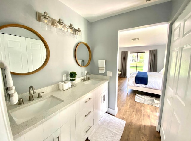 bathroom with wood-type flooring and dual vanity