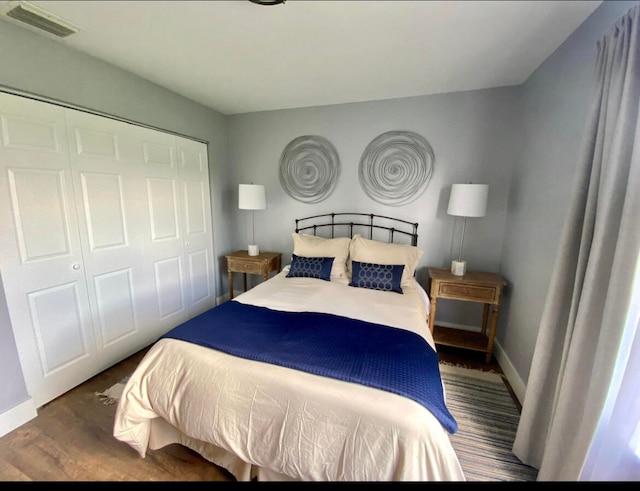 bedroom with hardwood / wood-style floors and a closet