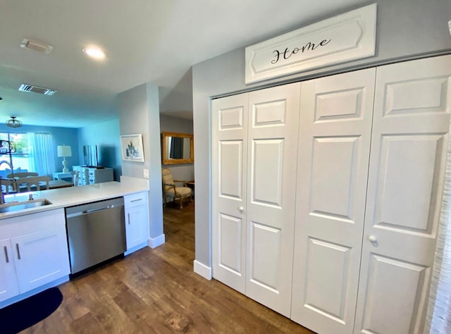 kitchen with white cabinets, dishwasher, dark hardwood / wood-style flooring, and sink