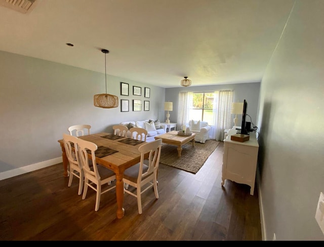 dining space with dark hardwood / wood-style flooring