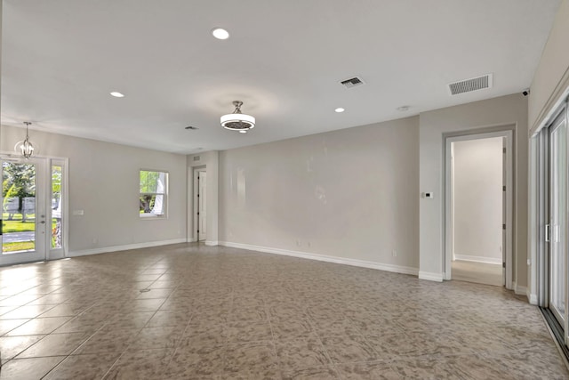 tiled spare room with baseboards, visible vents, and recessed lighting