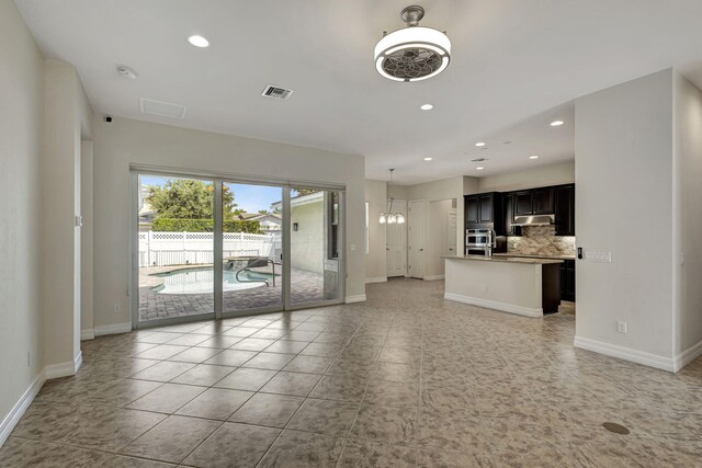 unfurnished living room featuring light tile patterned flooring, recessed lighting, visible vents, and baseboards