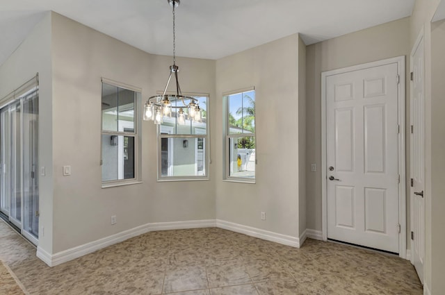 unfurnished dining area with baseboards