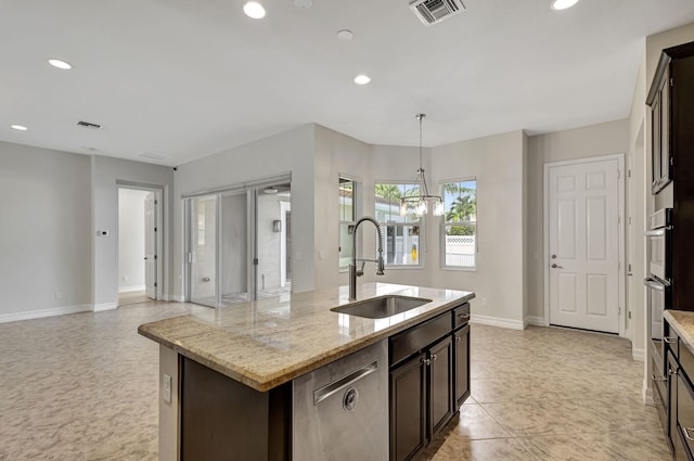 kitchen with a center island with sink, a sink, visible vents, and recessed lighting