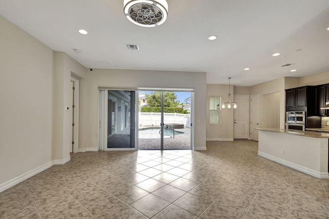 interior space with an inviting chandelier and light tile patterned floors