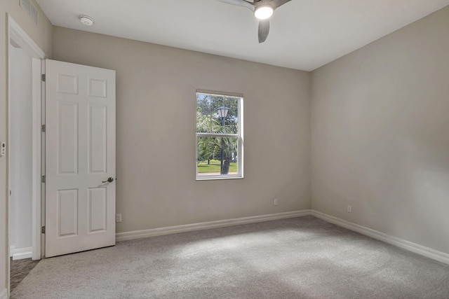 spare room with visible vents, baseboards, ceiling fan, and carpet flooring