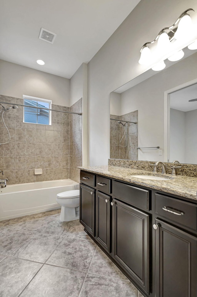 bathroom with toilet, vanity, visible vents, and shower / bathing tub combination